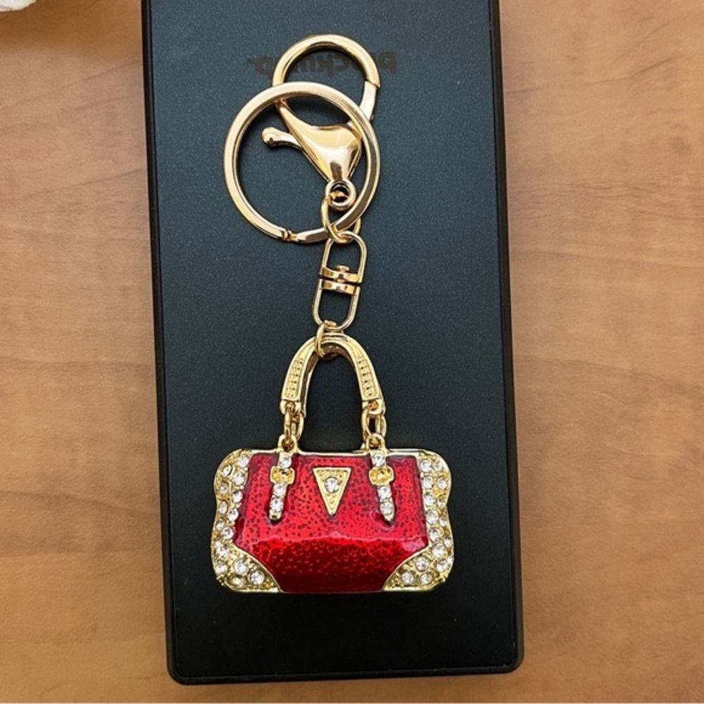 Keychain Ruby Red and crystal purse. NIP.  1.75 x 1.75 x.5” width. Length 4.25”
